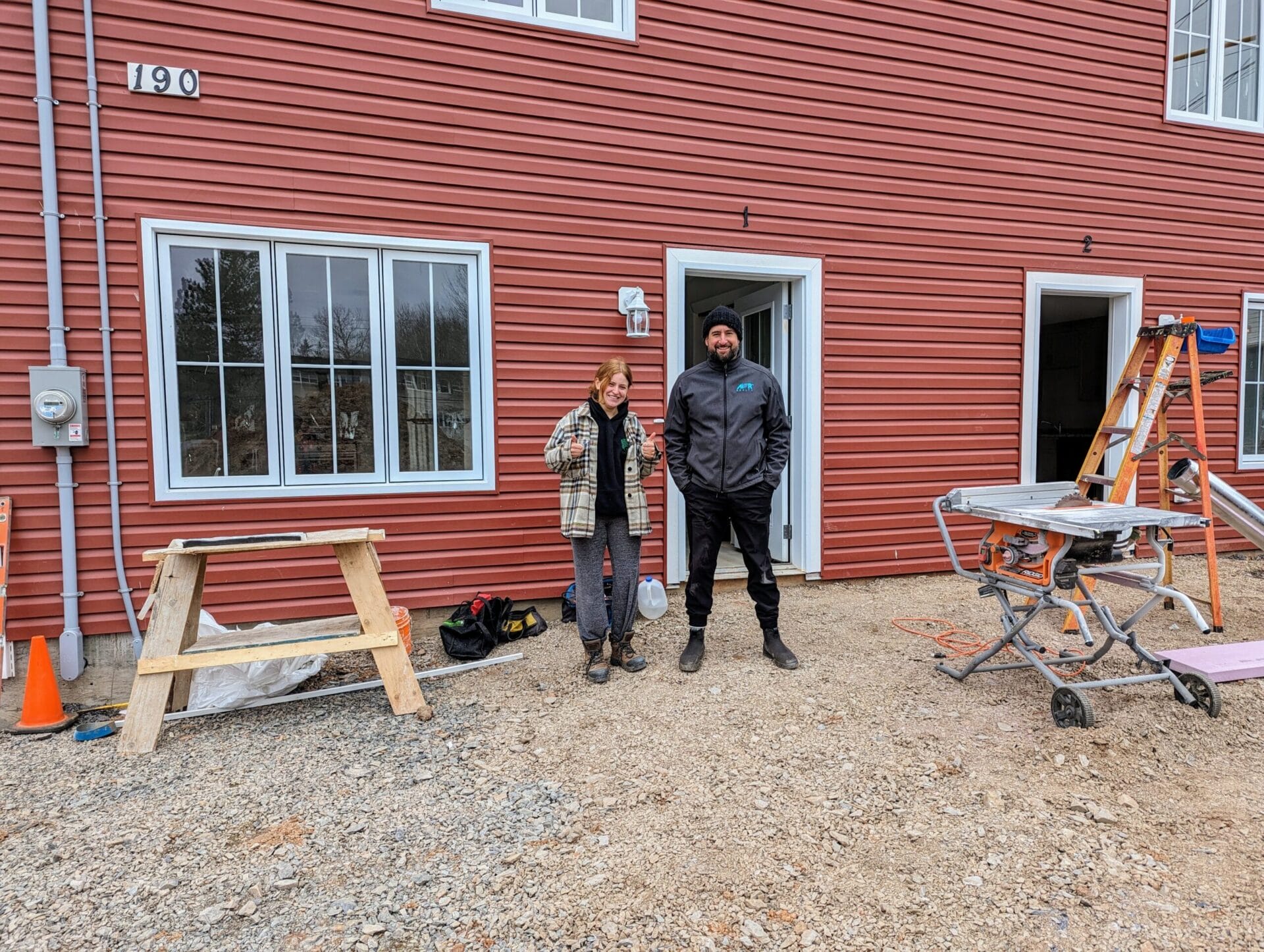 Two people outside of Wolfville property